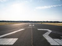 the runway at an airport with signs on it that indicate where to go and where you are standing