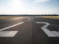 the runway at an airport with signs on it that indicate where to go and where you are standing