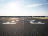 the runway at an airport with signs on it that indicate where to go and where you are standing