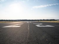 the runway at an airport with signs on it that indicate where to go and where you are standing