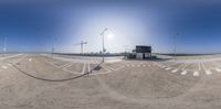 two trucks driving along an airport runway in the sun with arrows and poles above them