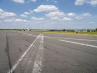 an airport has a runway with a yellow and black sign pointing to one side of the runway