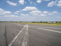 an airport has a runway with a yellow and black sign pointing to one side of the runway