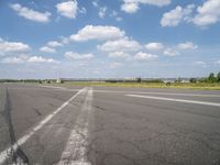 an airport has a runway with a yellow and black sign pointing to one side of the runway