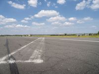 an airport has a runway with a yellow and black sign pointing to one side of the runway