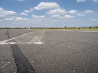 an airport has a runway with a yellow and black sign pointing to one side of the runway