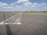 an airport has a runway with a yellow and black sign pointing to one side of the runway