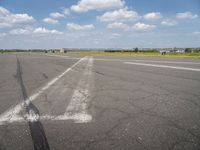 an airport has a runway with a yellow and black sign pointing to one side of the runway