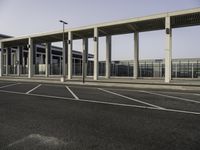 a view from across the parking lot at an airport terminal and its roof is almost closed