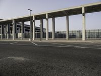 a view from across the parking lot at an airport terminal and its roof is almost closed