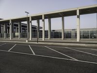 a view from across the parking lot at an airport terminal and its roof is almost closed