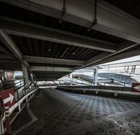 the walkway of an airport has an arrow painted on it and other signs in front