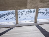 the shadow of two people and a snowboarder are seen from behind the railing