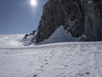 the man is skiing on the snowy mountain trail on his skis, and he's going downhill