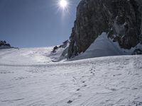 the man is skiing on the snowy mountain trail on his skis, and he's going downhill