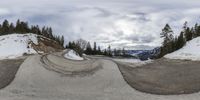 an image of snowboarder in midair going down hill in the mountains at the same time