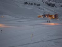 snow is piled over at a ski slope in the mountains with snow everywhere around it