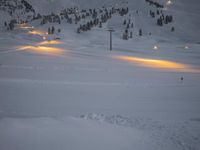 snow is piled over at a ski slope in the mountains with snow everywhere around it
