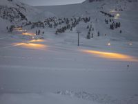 snow is piled over at a ski slope in the mountains with snow everywhere around it