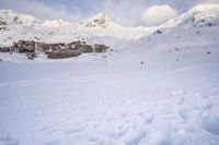 a skier makes his way up to the ski lodge in front of the mountain peaks