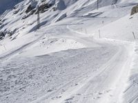 a lone skier making his way through a steep slope on snow covered skis in the alps