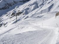 a lone skier making his way through a steep slope on snow covered skis in the alps