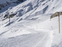 a lone skier making his way through a steep slope on snow covered skis in the alps