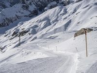 a lone skier making his way through a steep slope on snow covered skis in the alps