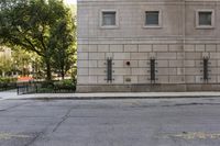 the fire hydrant is painted red in front of an apartment building that is outside