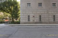 the fire hydrant is painted red in front of an apartment building that is outside