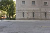 the fire hydrant is painted red in front of an apartment building that is outside