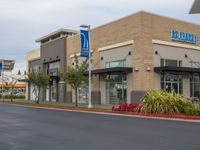 an american health university hospital is shown here, with several small signage, and a parking lot