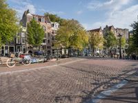 the bicycle path is full with bicycles and bicycles on the streets in front of brick buildings