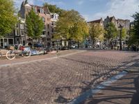 the bicycle path is full with bicycles and bicycles on the streets in front of brick buildings