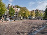 the bicycle path is full with bicycles and bicycles on the streets in front of brick buildings