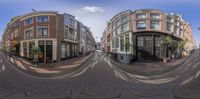 two 360 - views of a brick paved area and tall buildings in the background and a few people are sitting outside