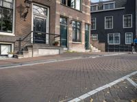 a brick road with two black doors on the one side of it and brick steps along both sides