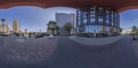 the view from inside a mirror showing the architecture and sky with buildings in the background