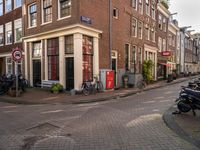 an image of buildings at the end of the street with bikes in front of it