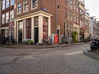 an image of buildings at the end of the street with bikes in front of it