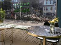 the restaurant is open to the public in holland, and features bikes parked near a window