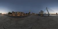 the circular photograph is on the edge of a walkway and in front of the city skyline