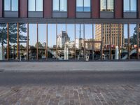 a view of some buildings in the background, as if from outside a glassy building