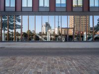 a view of some buildings in the background, as if from outside a glassy building