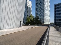 two buildings on either side of a walkway, with a bench in the middle of one