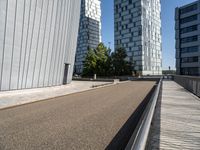 two buildings on either side of a walkway, with a bench in the middle of one