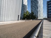 two buildings on either side of a walkway, with a bench in the middle of one