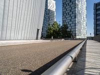 two buildings on either side of a walkway, with a bench in the middle of one