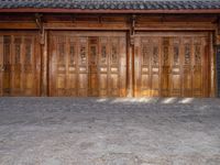 old wooden double doors set in an ancient building in china's beijing suburbs,