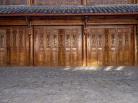 old wooden double doors set in an ancient building in china's beijing suburbs,